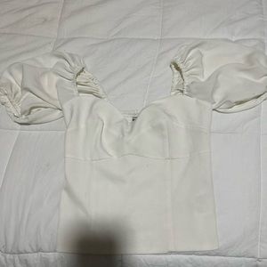 white shirt , mid length sleeves that cuff
